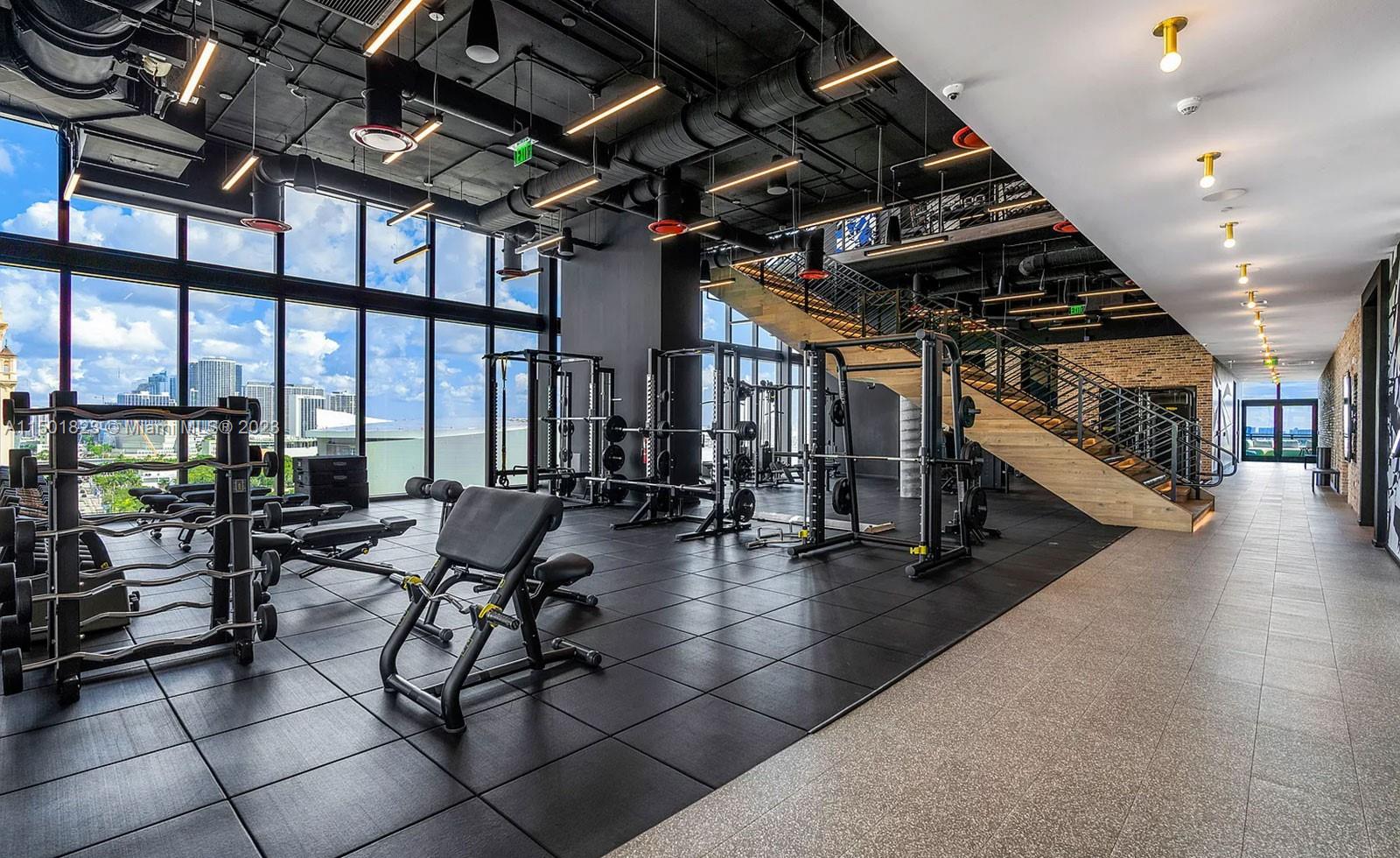398 Northeast 5th Street, Unit 2804 Miami, FL 33132 - Photo 13 of 17 a view of a hall with exercise machine