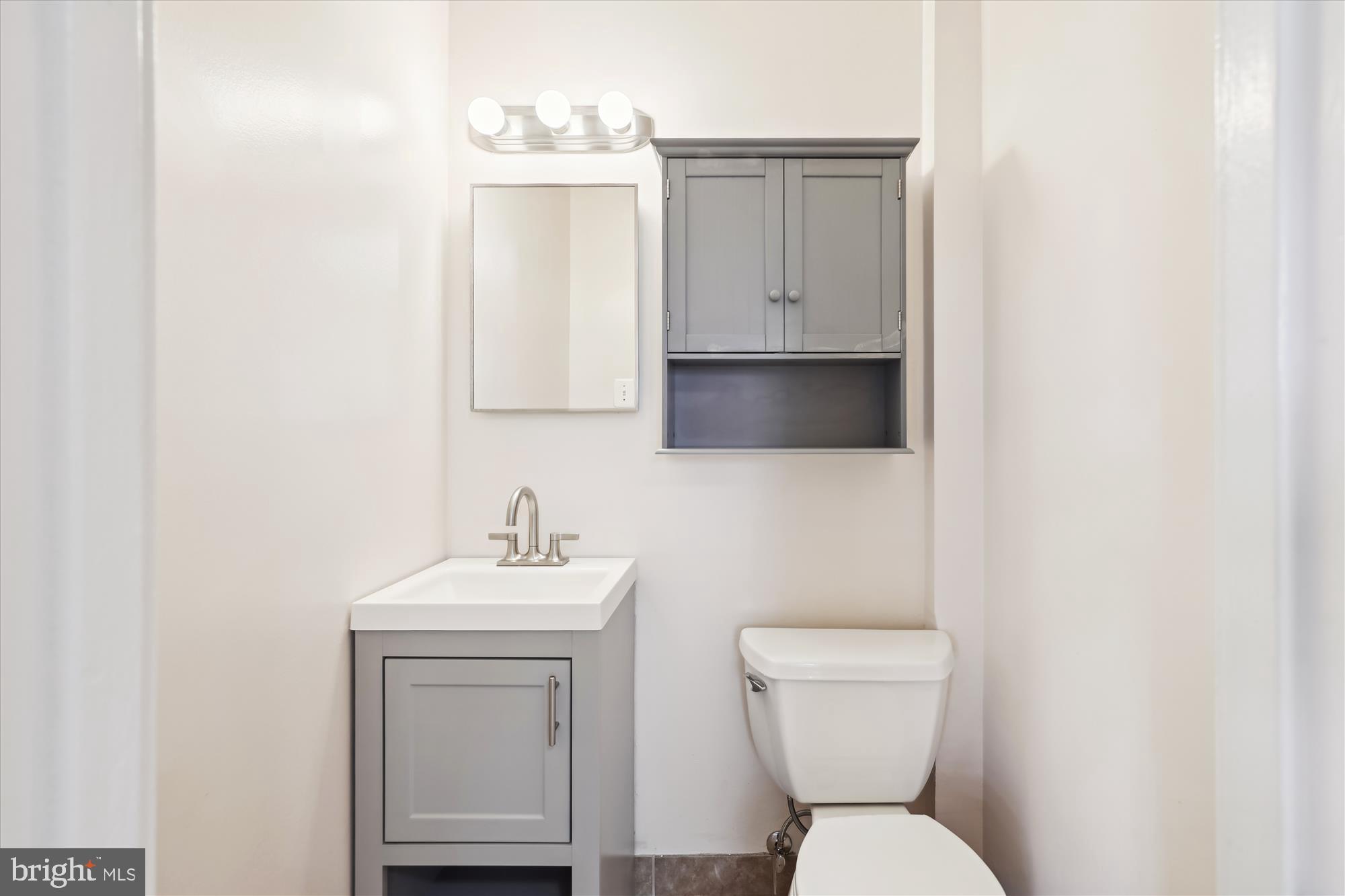 5909 Quantrell Avenue, Unit 203 Alexandria, VA 22312 - Photo 12 of 33 a bathroom with a toilet sink and mirror