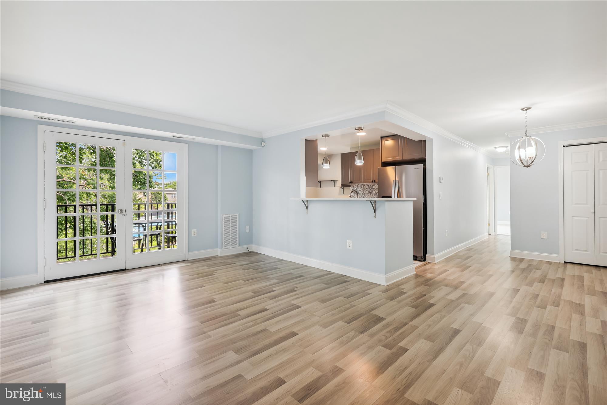 5909 Quantrell Avenue, Unit 203 Alexandria, VA 22312 - Photo 2 of 33 a view of a big room with wooden floor and windows