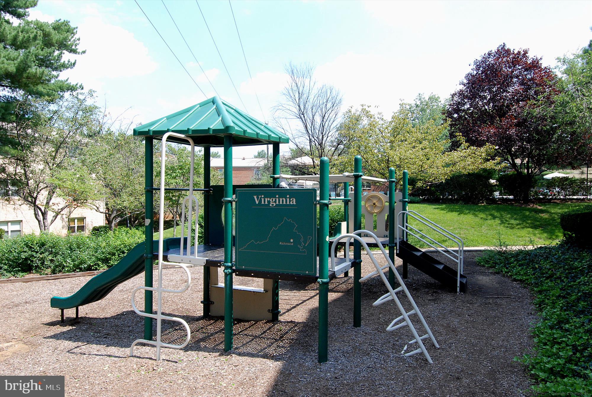 5909 Quantrell Avenue, Unit 203 Alexandria, VA 22312 - Photo 27 of 33 a view of a table and chairs in backyard of the house