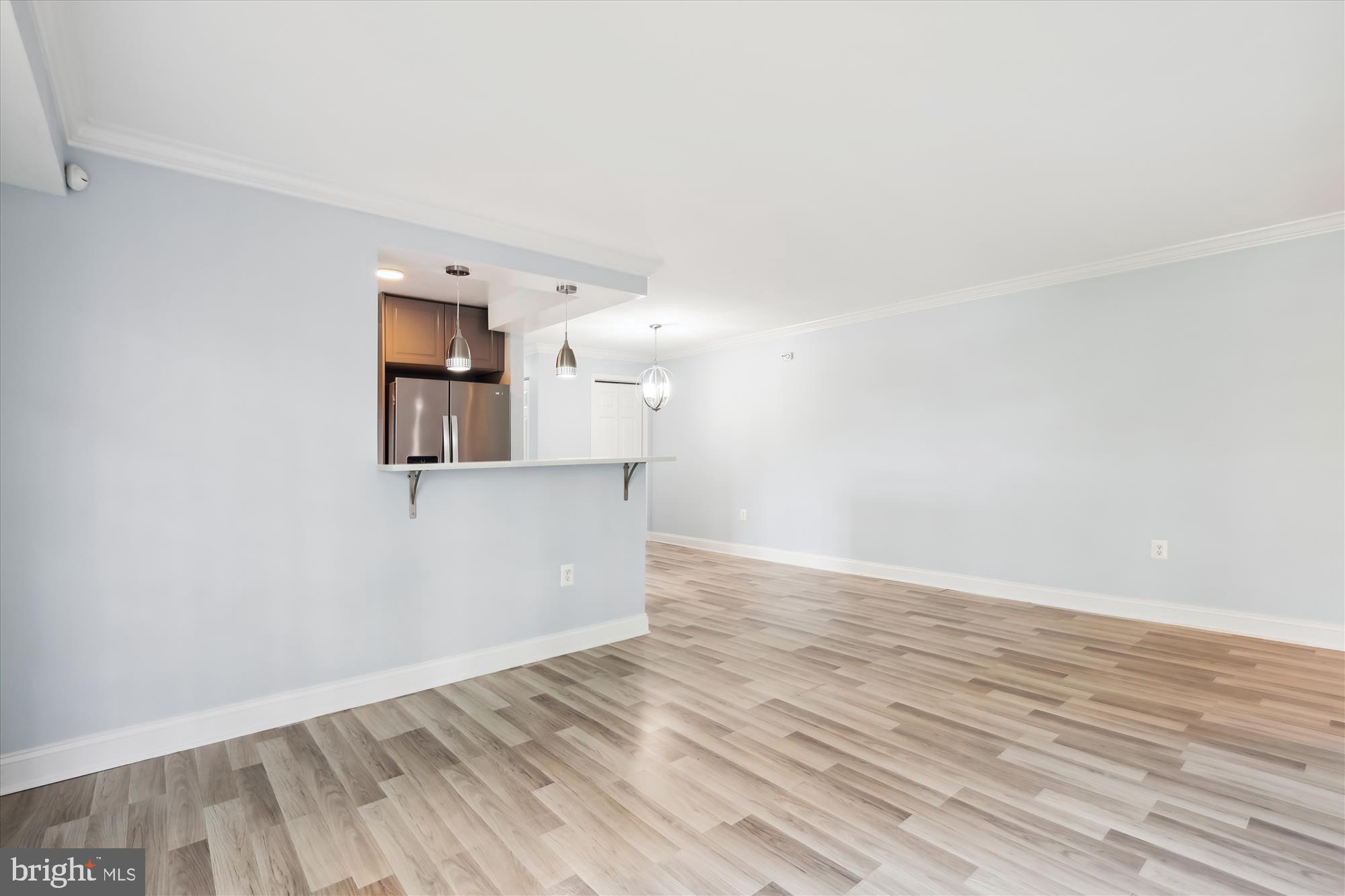 5909 Quantrell Avenue, Unit 203 Alexandria, VA 22312 - Photo 3 of 33 a view of a room with wooden floor and cabinet