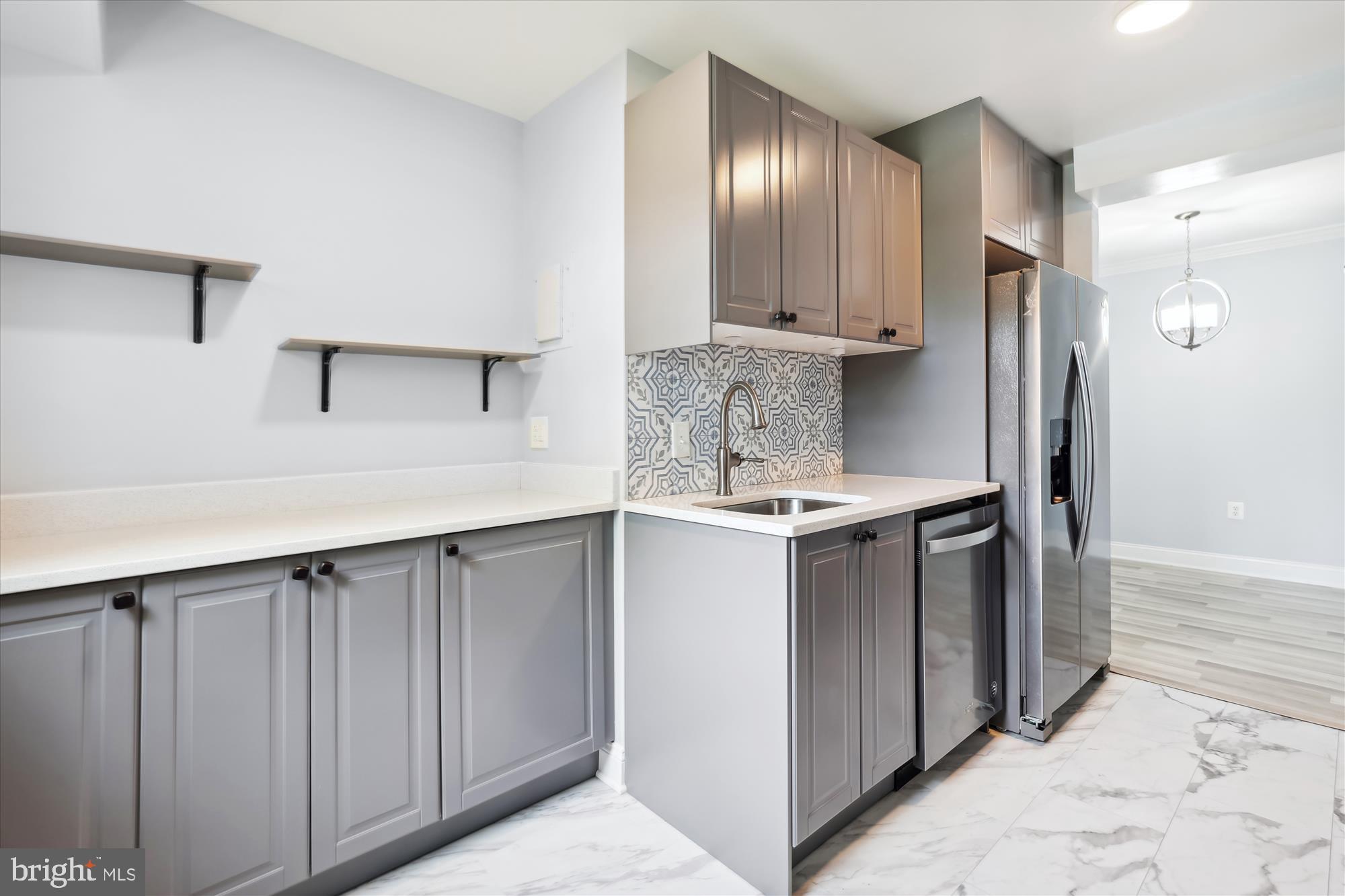 5909 Quantrell Avenue, Unit 203 Alexandria, VA 22312 - Photo 5 of 33 a kitchen with stainless steel appliances granite countertop a refrigerator and a sink