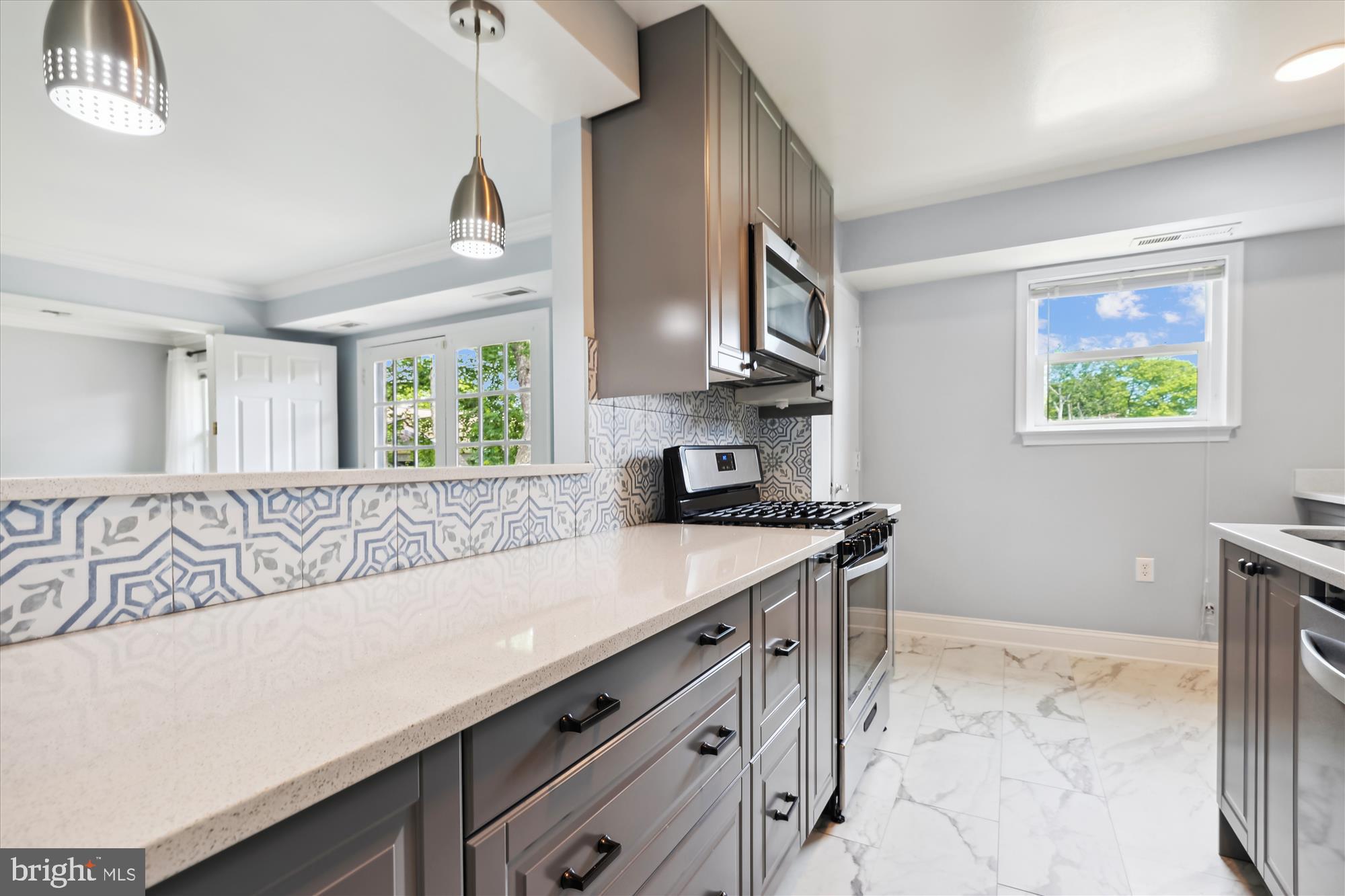 5909 Quantrell Avenue, Unit 203 Alexandria, VA 22312 - Photo 6 of 33 a kitchen with stainless steel appliances a sink a stove cabinets and a window