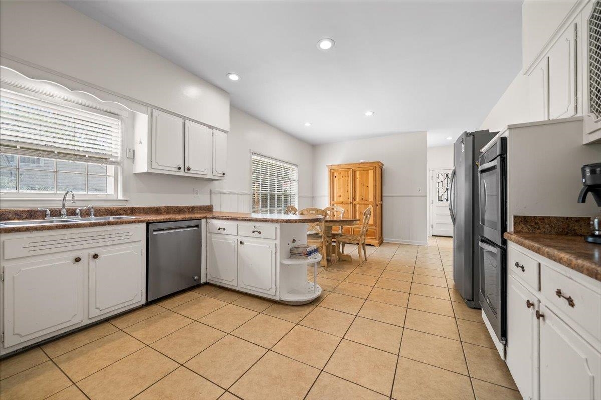 1273 Brookfield Road Memphis, TN 38119 - Photo 15 of 40 Spacious kitchen featuring tile flooring, white cabinetry, a built-in dishwasher, and recessed lighting
