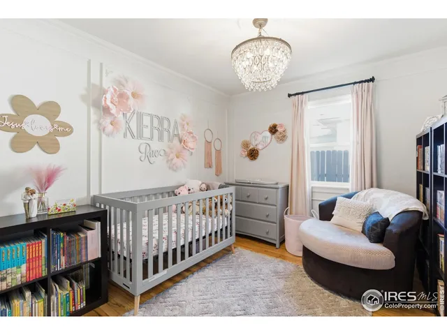 a bedroom with furniture and a large window