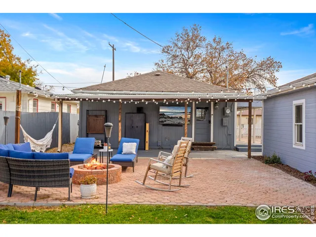 a building outdoor space with patio furniture and potted plants