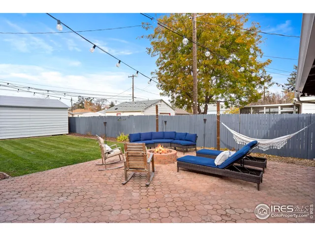 a backyard of a house with table and chairs