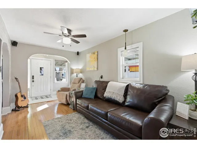 a living room with furniture ceiling fan and a rug