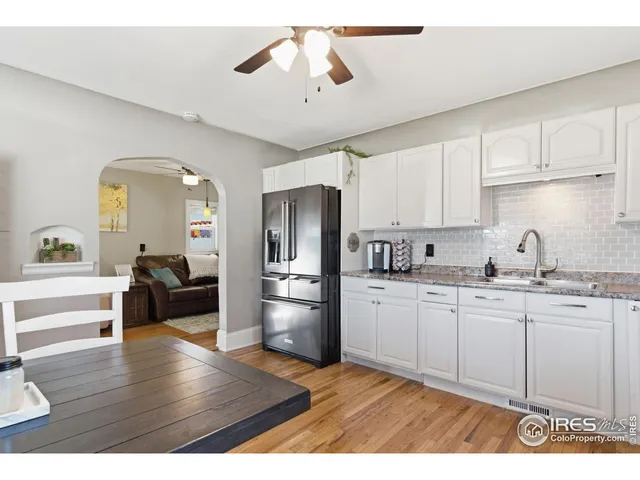 a kitchen with refrigerator cabinets and wooden floor