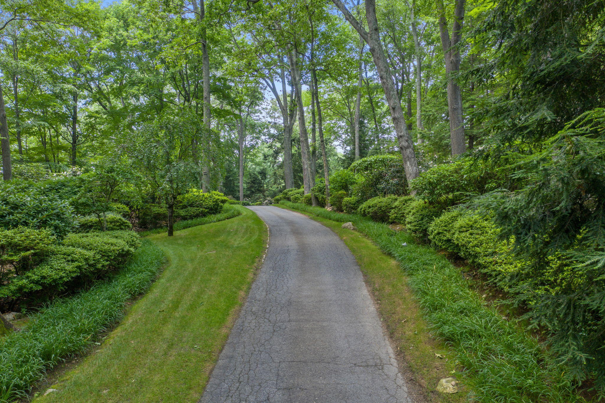 2061 Ponus Ridge Road New Canaan, CT 06840 - Photo 2 of 50 a view of a pathway with a park