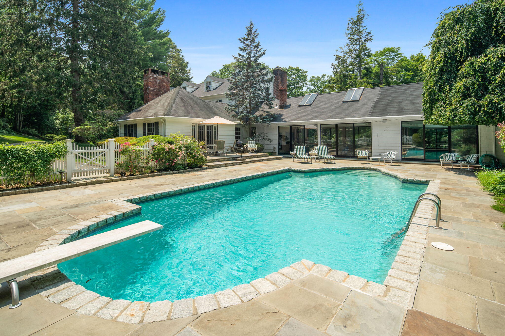 2061 Ponus Ridge Road New Canaan, CT 06840 - Photo 14 of 50 a view of a house with swimming pool and a yard