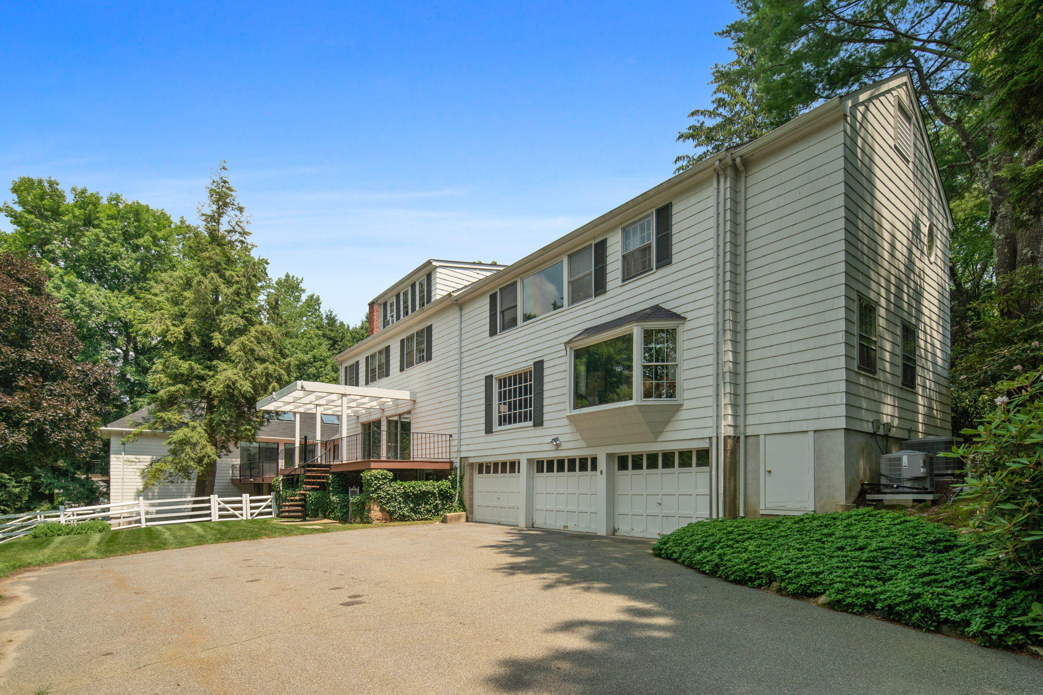 2061 Ponus Ridge Road New Canaan, CT 06840 - Photo 16 of 50 a front view of a house with a garden