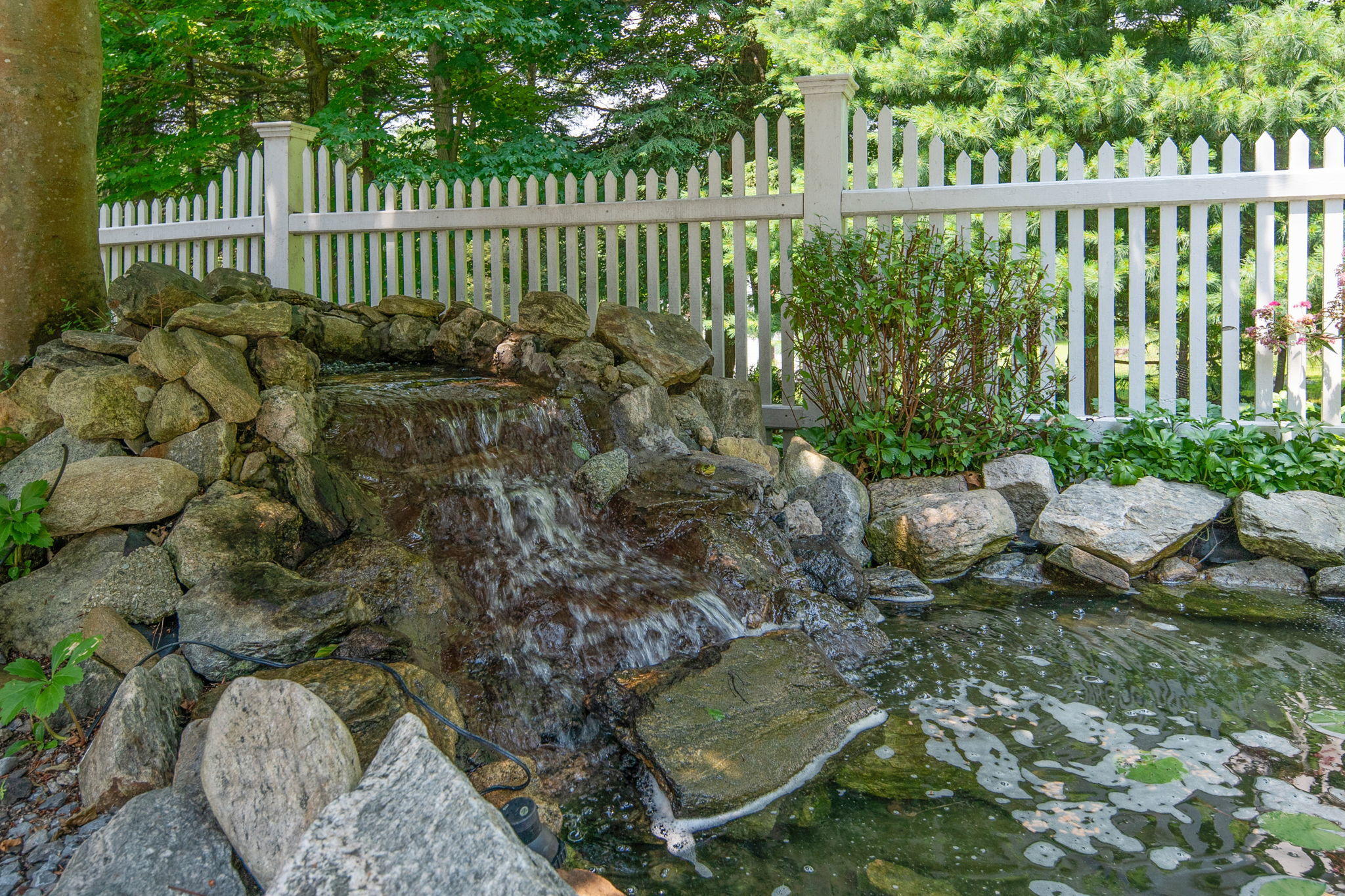 2061 Ponus Ridge Road New Canaan, CT 06840 - Photo 17 of 50 a garden view with a sitting space