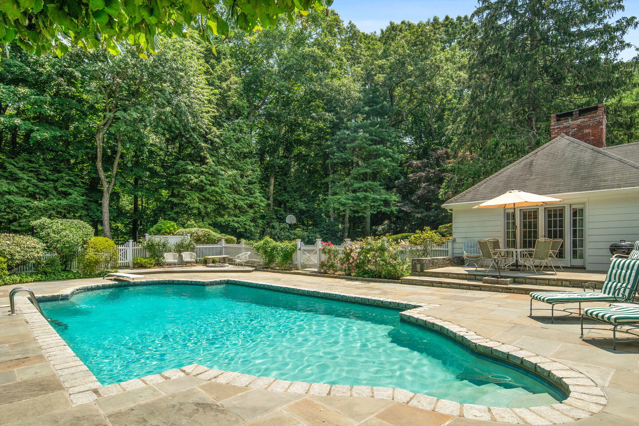 2061 Ponus Ridge Road New Canaan, CT 06840 - Photo 18 of 50 a view of a house with swimming pool and sitting area