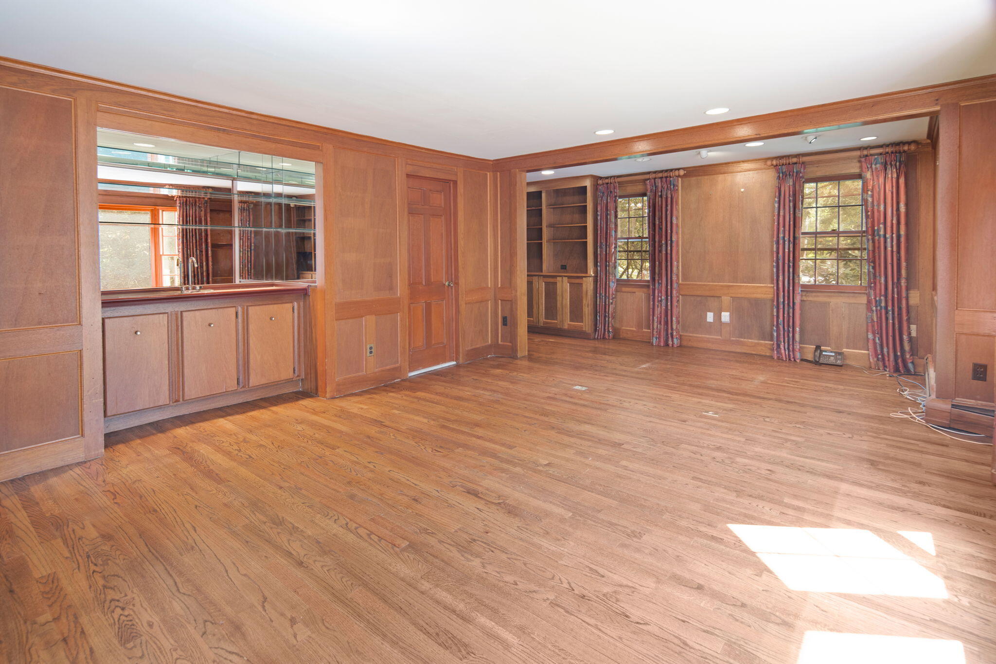 2061 Ponus Ridge Road New Canaan, CT 06840 - Photo 23 of 50 a view of an empty room with window and wooden floor