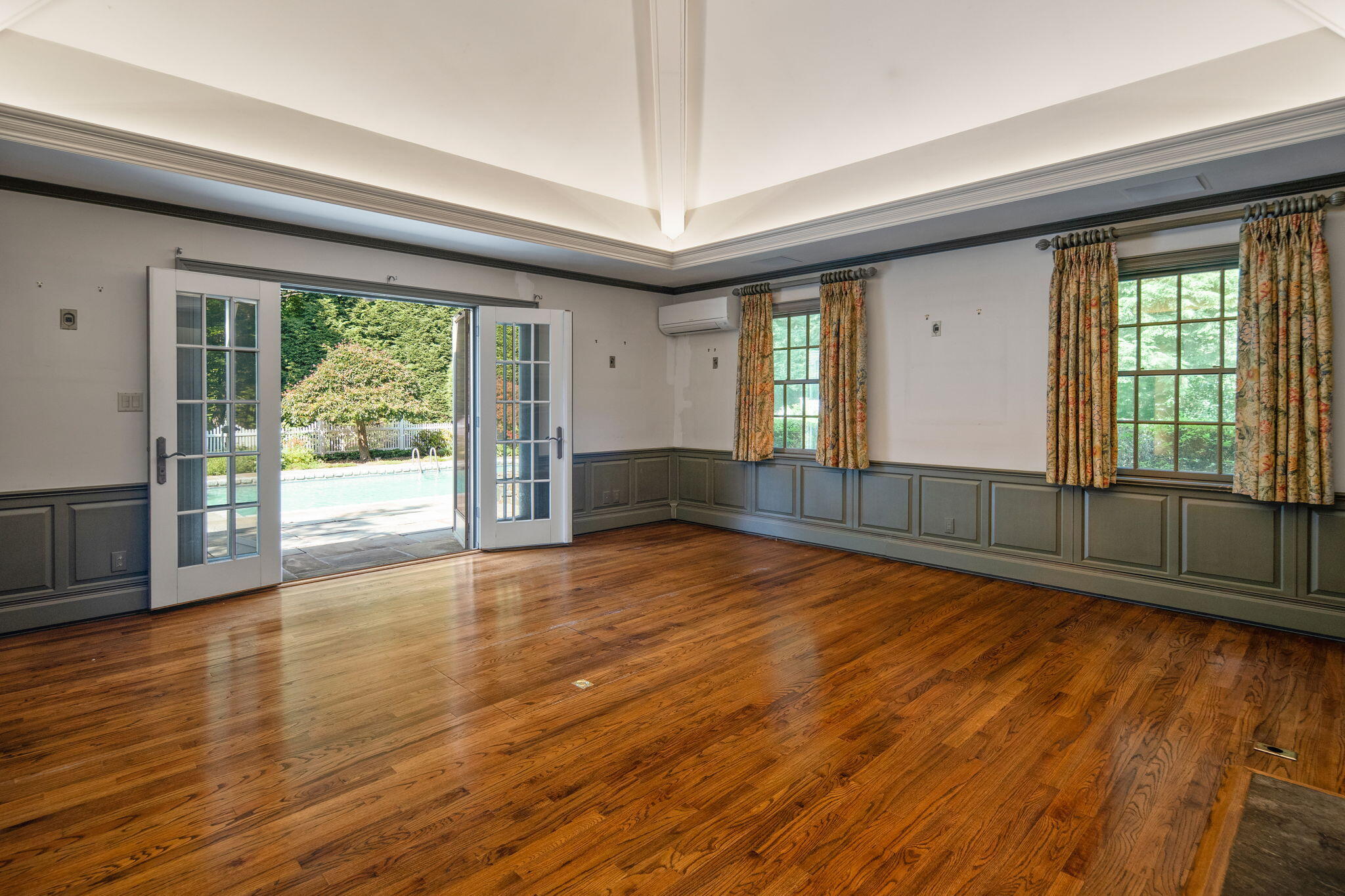 2061 Ponus Ridge Road New Canaan, CT 06840 - Photo 25 of 50 a view of an empty room with wooden floor and a window