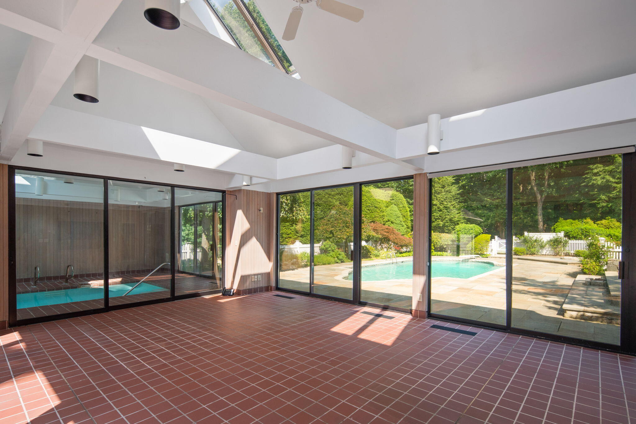 2061 Ponus Ridge Road New Canaan, CT 06840 - Photo 28 of 50 a view of an empty room with wooden floor and windows