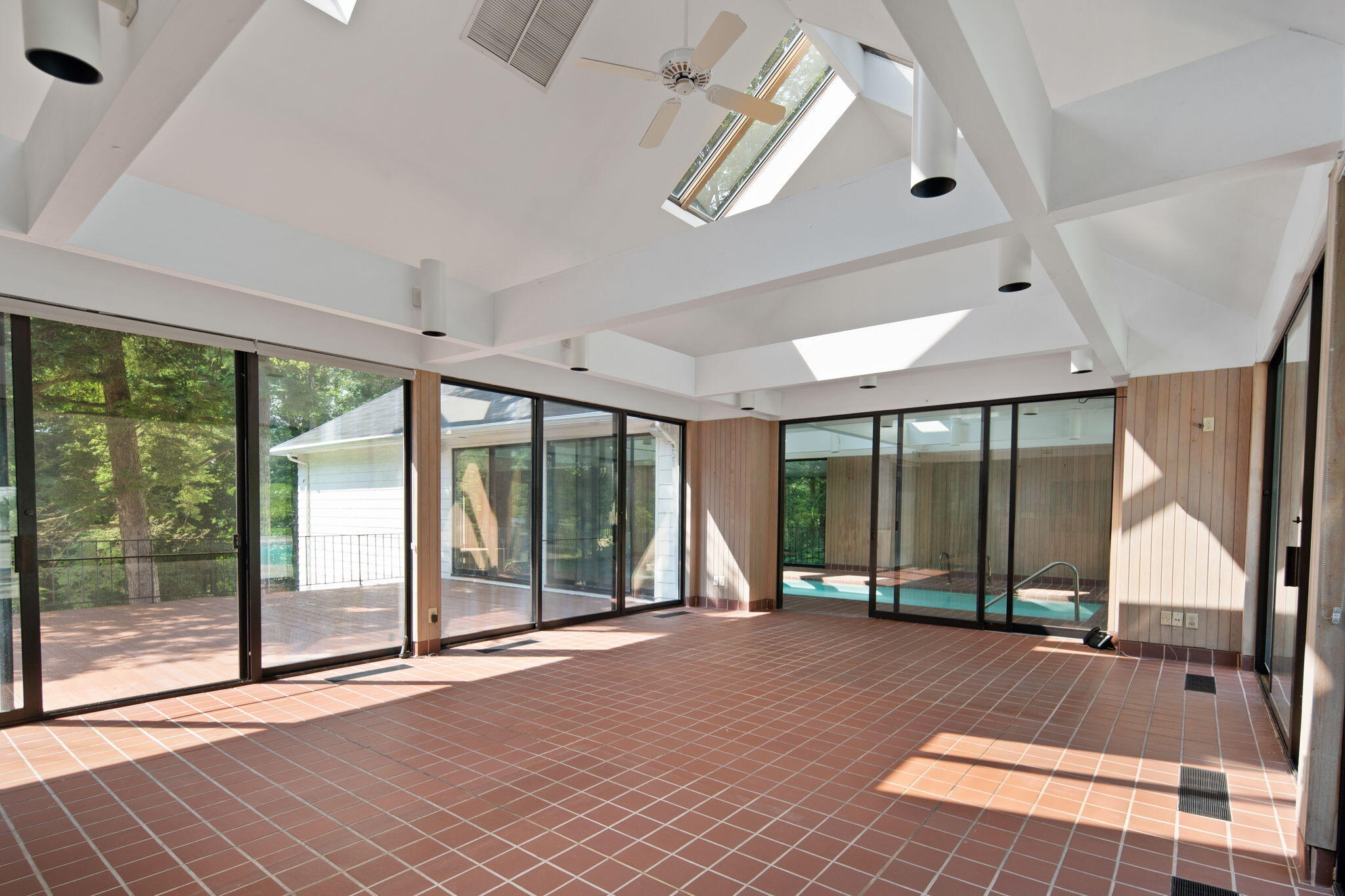 2061 Ponus Ridge Road New Canaan, CT 06840 - Photo 29 of 50 a view of an empty room with wooden floor and windows