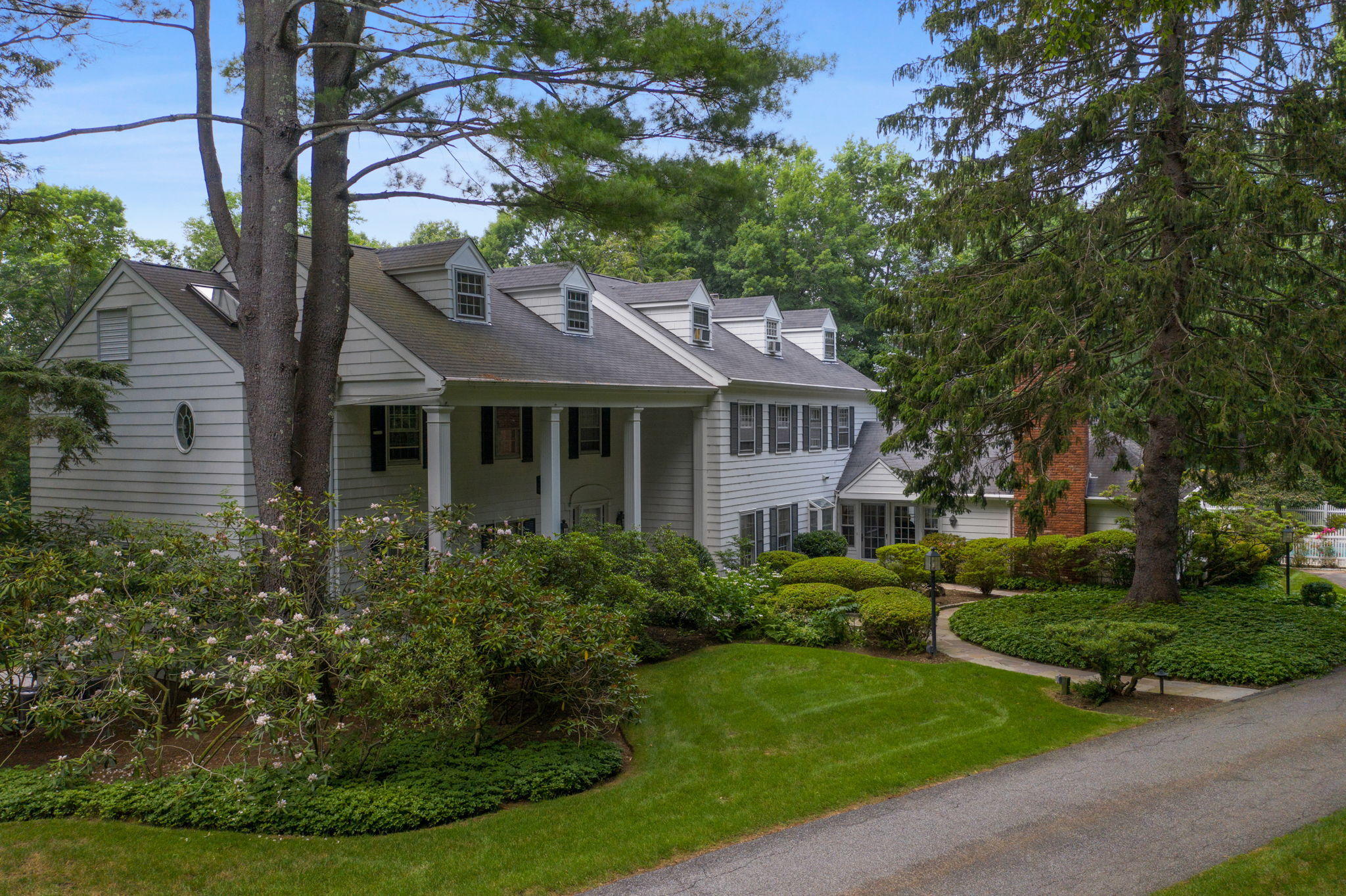 2061 Ponus Ridge Road New Canaan, CT 06840 - Photo 4 of 50 a front view of a house with a yard