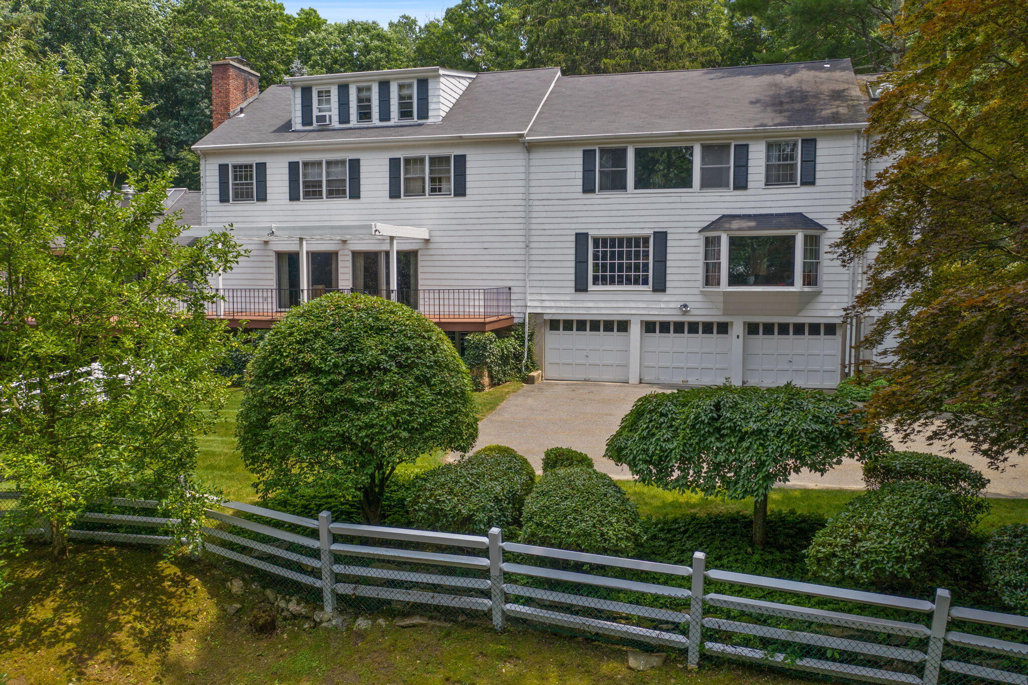 2061 Ponus Ridge Road New Canaan, CT 06840 - Photo 42 of 50 a front view of a house with a yard