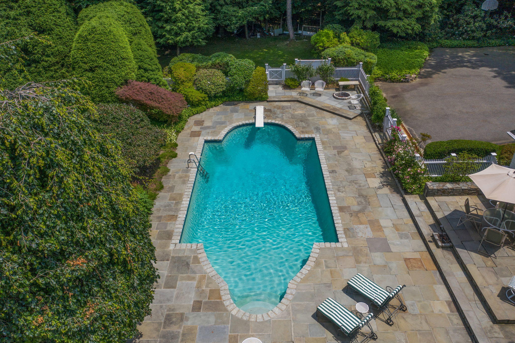 2061 Ponus Ridge Road New Canaan, CT 06840 - Photo 43 of 50 a backyard of a house with lots of green space