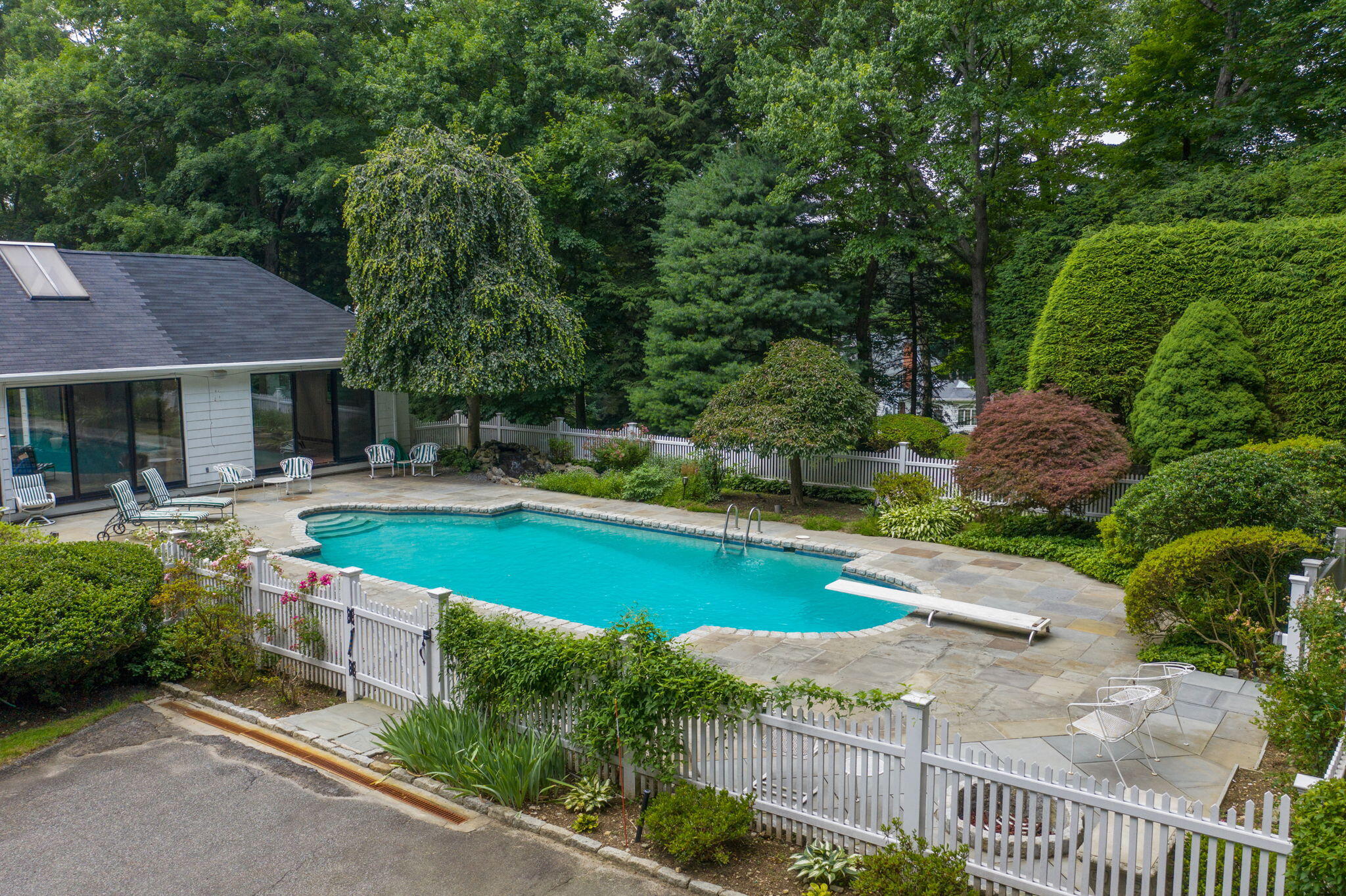 2061 Ponus Ridge Road New Canaan, CT 06840 - Photo 45 of 50 a swimming pool with outdoor seating and yard
