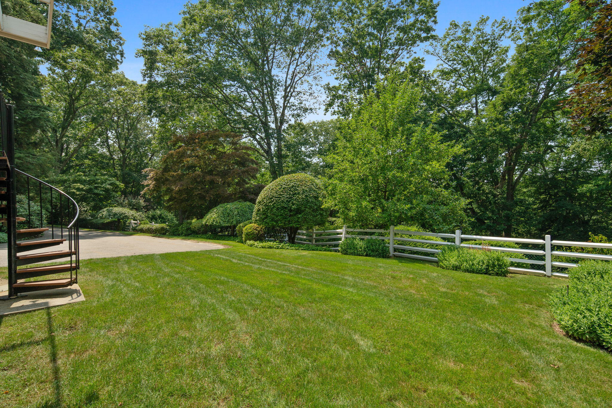 2061 Ponus Ridge Road New Canaan, CT 06840 - Photo 7 of 50 a backyard of a house with lots of green space