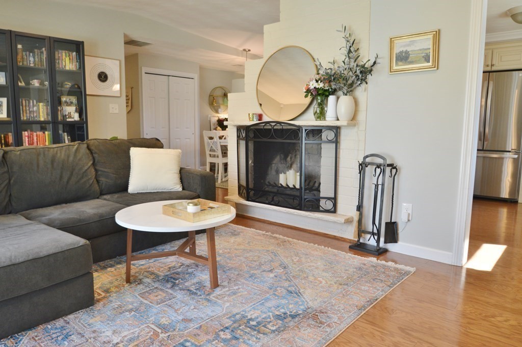 24 Raleigh Road Framingham, MA 01701 - Photo 11 of 37 a living room with furniture a mirror and a fireplace