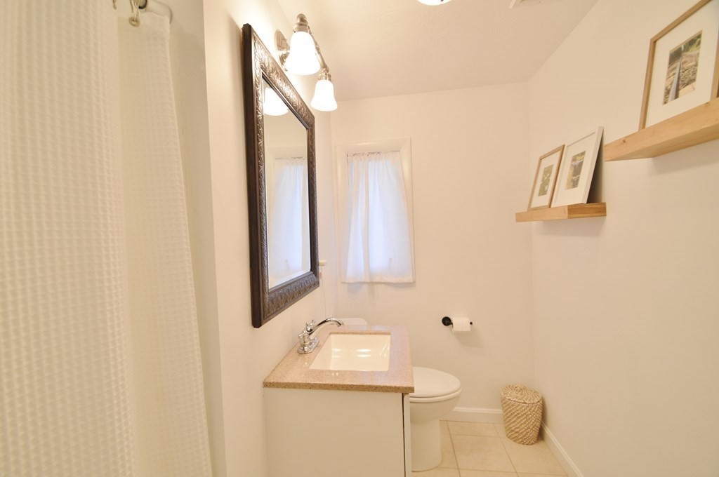 24 Raleigh Road Framingham, MA 01701 - Photo 20 of 37 a bathroom with a sink and mirror with toilet