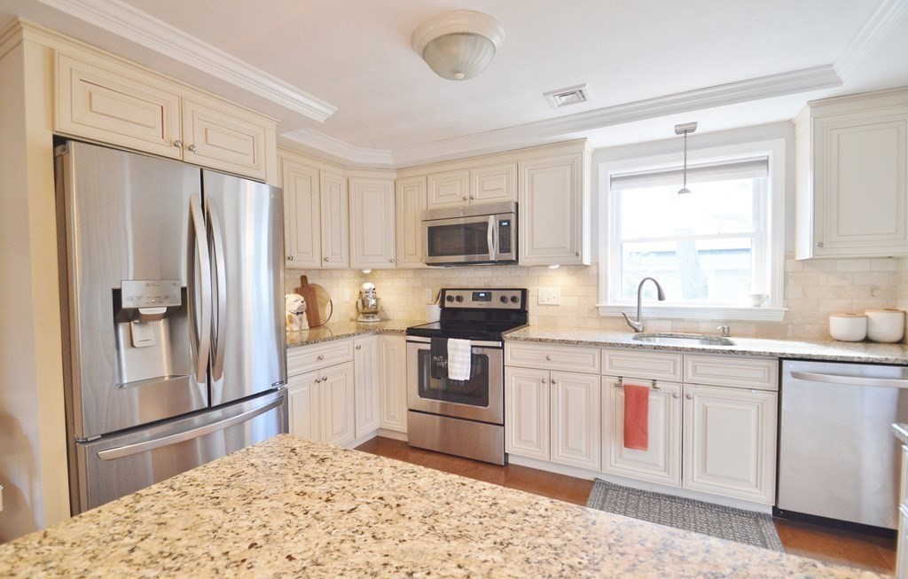 24 Raleigh Road Framingham, MA 01701 - Photo 3 of 37 a kitchen with granite countertop a refrigerator stove microwave and sink