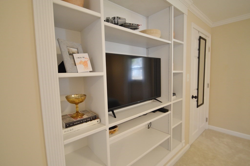 24 Raleigh Road Framingham, MA 01701 - Photo 31 of 37 a living room with a flat screen tv and gym equipment