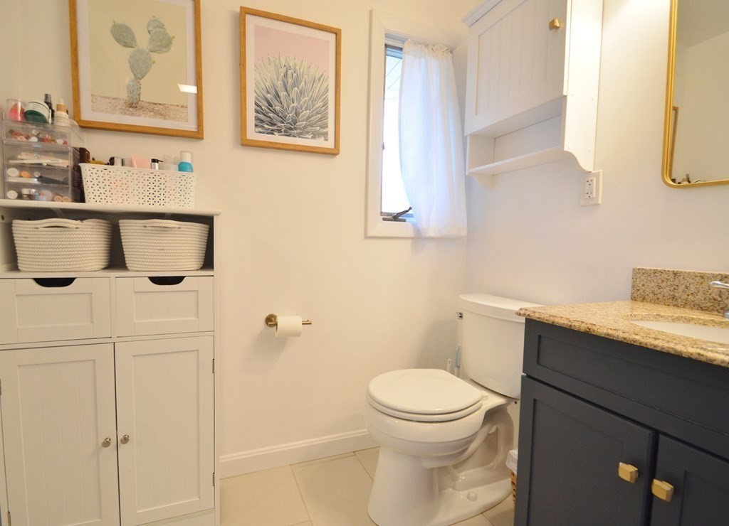 24 Raleigh Road Framingham, MA 01701 - Photo 33 of 37 a bathroom with a granite countertop sink a toilet and mirror