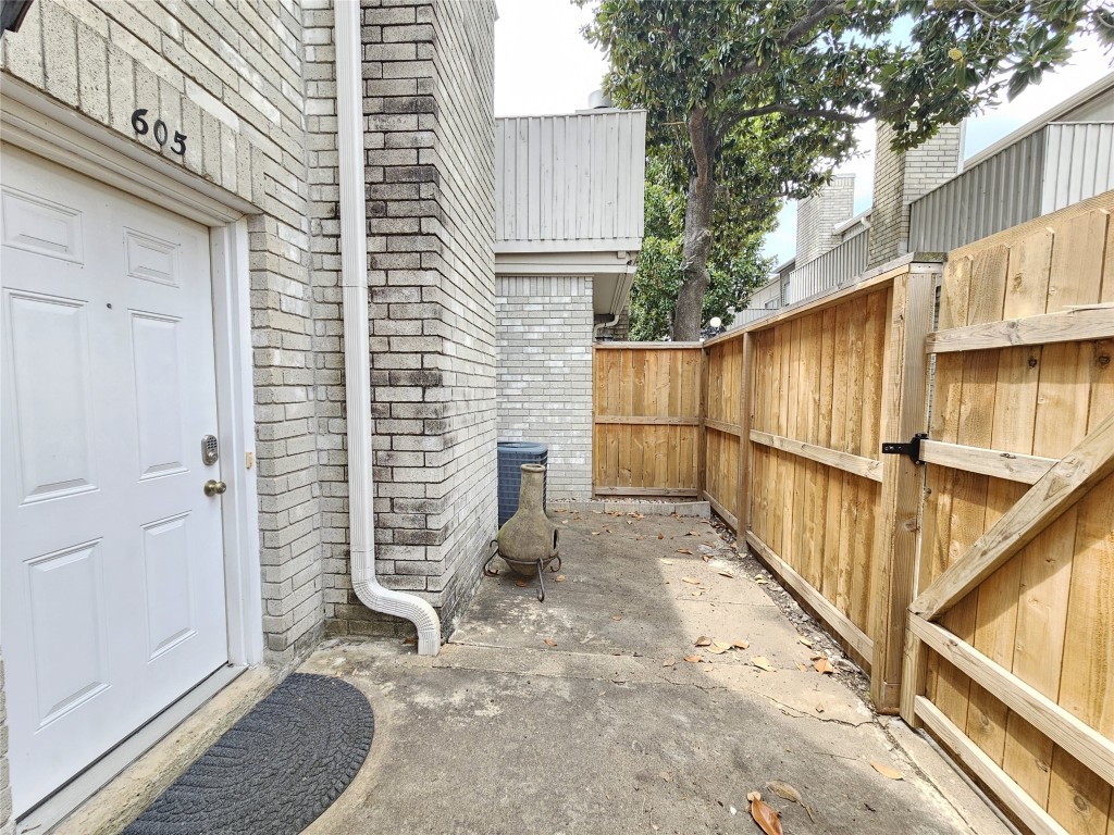 3800 Tanglewilde Street, Unit 605 Houston, TX 77063 - Photo 2 of 13 a view of a backyard with wooden fence and a stairs