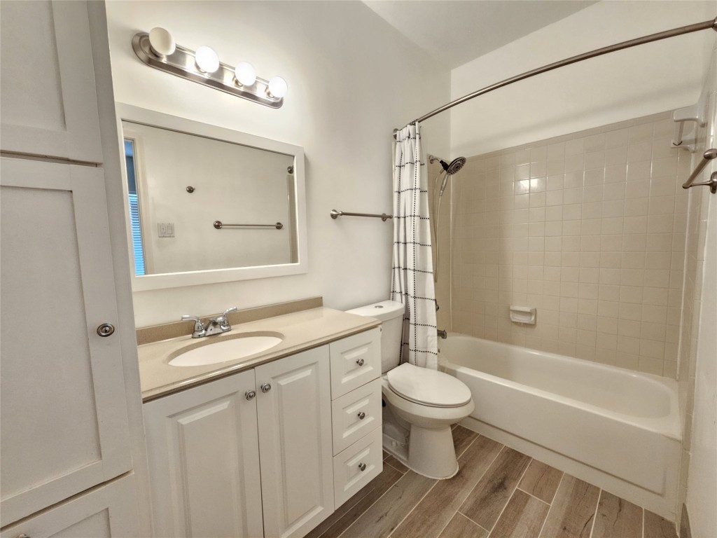 3800 Tanglewilde Street, Unit 605 Houston, TX 77063 - Photo 7 of 13 a bathroom with a granite countertop sink toilet a mirror and shower