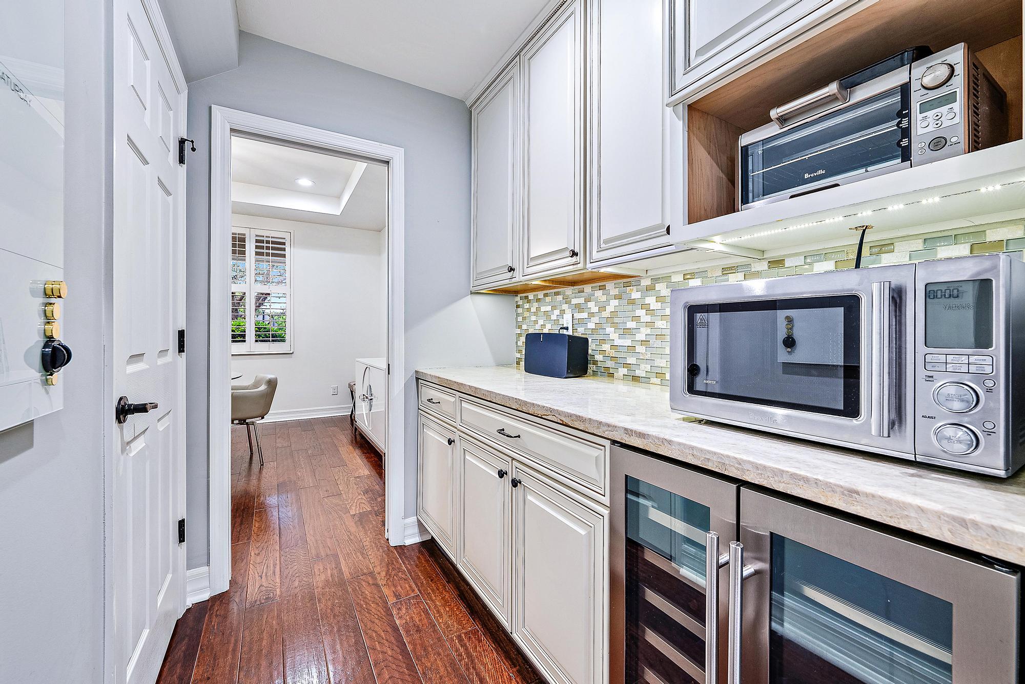2702 West Mallory Boulevard Jupiter, FL 33458 - Photo 11 of 39 a view of a hallway with wooden floor and staircase