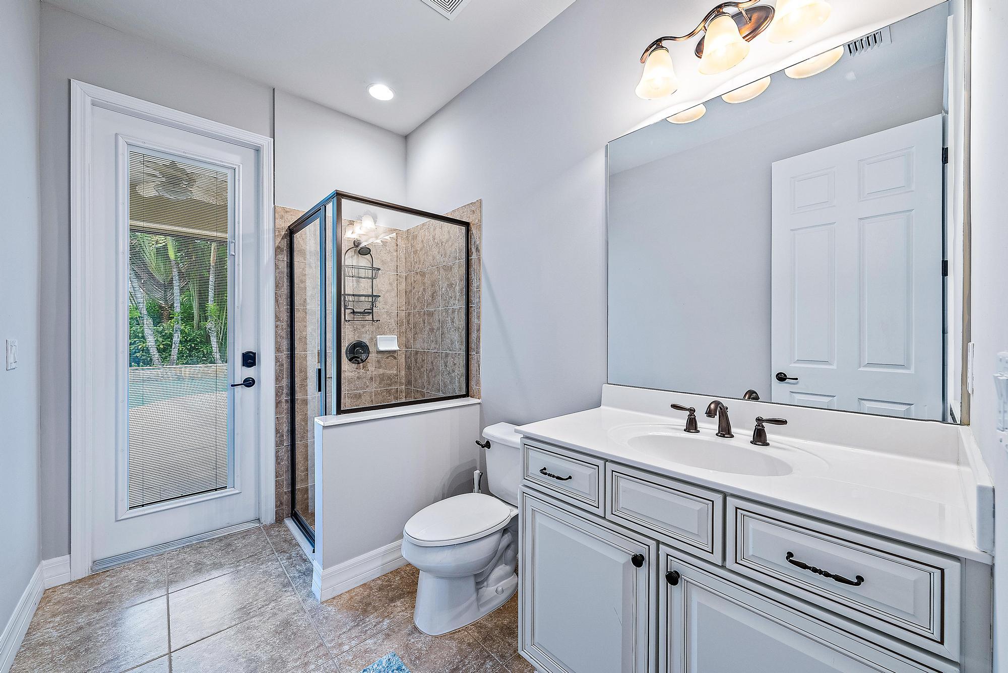 2702 West Mallory Boulevard Jupiter, FL 33458 - Photo 15 of 39 a bathroom with a sink a toilet and shower