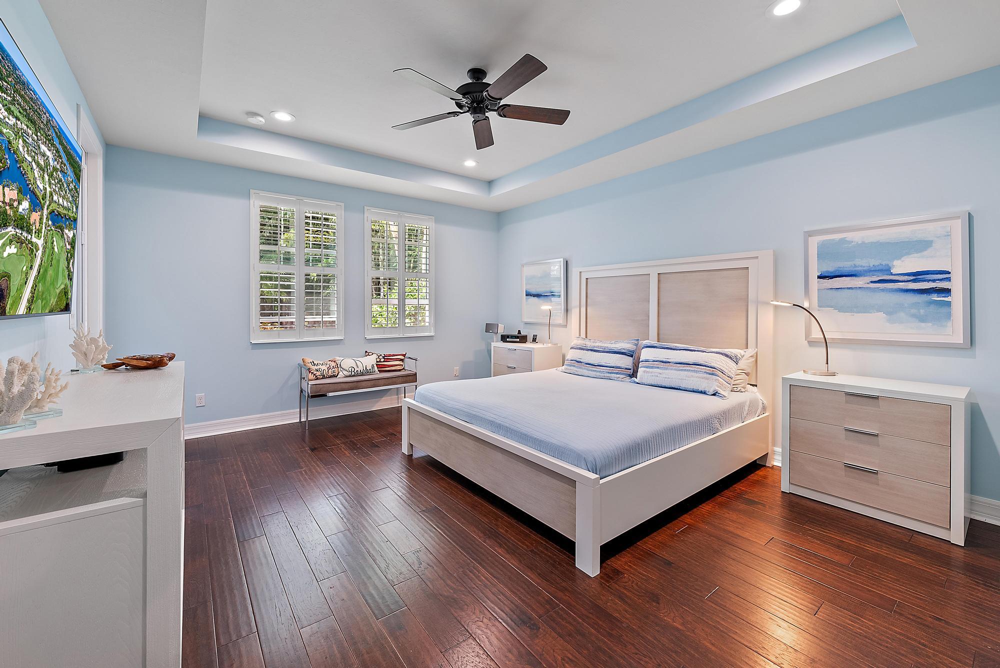 2702 West Mallory Boulevard Jupiter, FL 33458 - Photo 17 of 39 a bedroom with a bed and a dresser