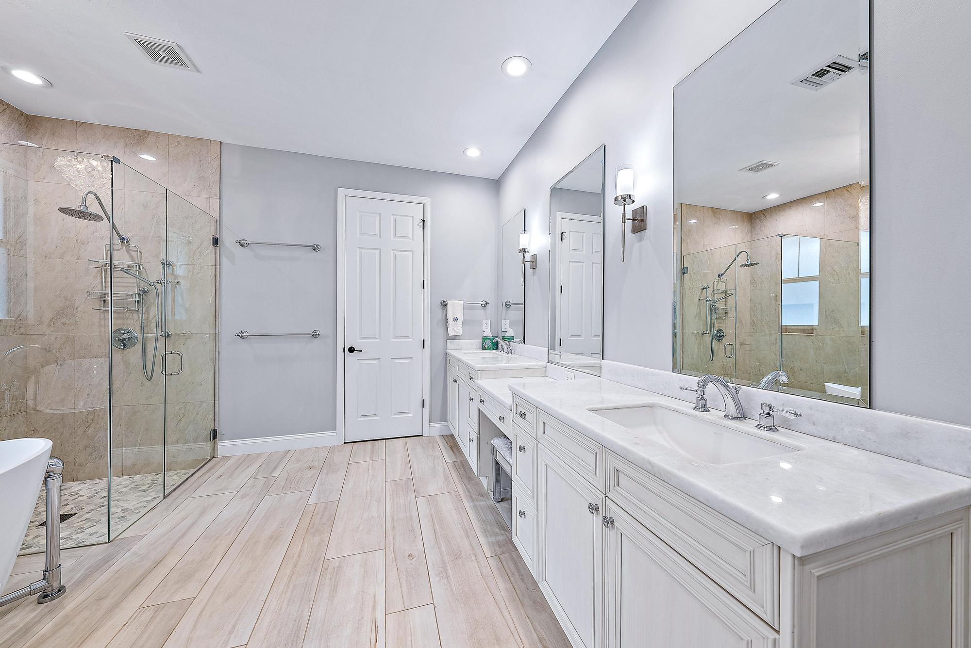 2702 West Mallory Boulevard Jupiter, FL 33458 - Photo 20 of 39 a spacious bathroom with a double vanity sink mirror and shower