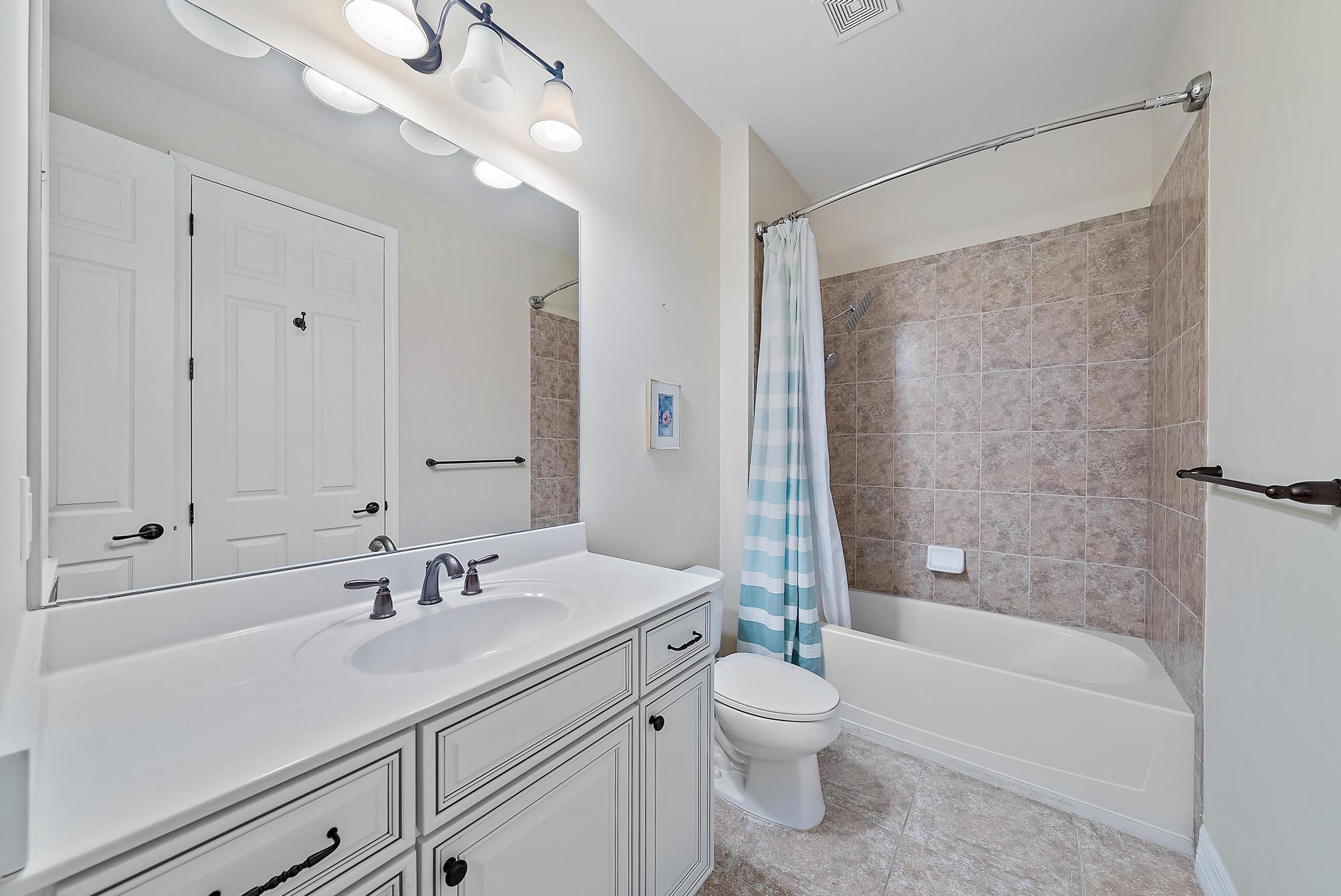 2702 West Mallory Boulevard Jupiter, FL 33458 - Photo 23 of 39 a bathroom with a sink a toilet and shower