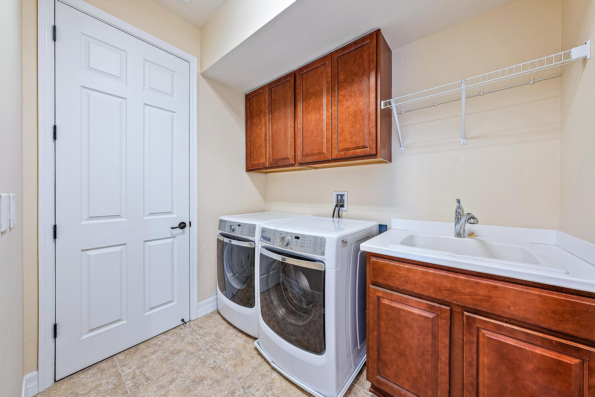 2702 West Mallory Boulevard Jupiter, FL 33458 - Photo 24 of 39 a utility room with sink dryer and washer