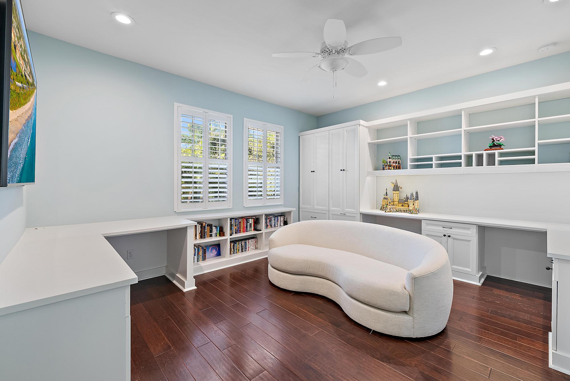 2702 West Mallory Boulevard Jupiter, FL 33458 - Photo 25 of 39 a living room with furniture and a wooden floor