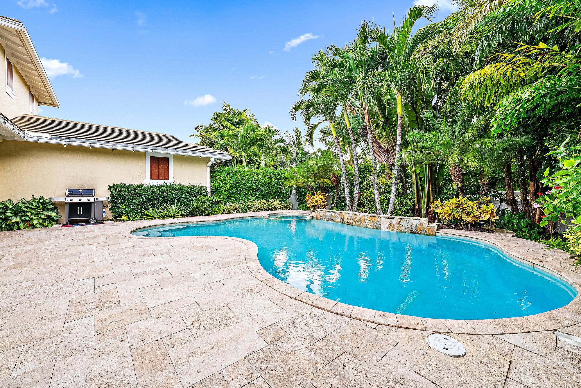 2702 West Mallory Boulevard Jupiter, FL 33458 - Photo 29 of 39 a view of a swimming pool with a patio