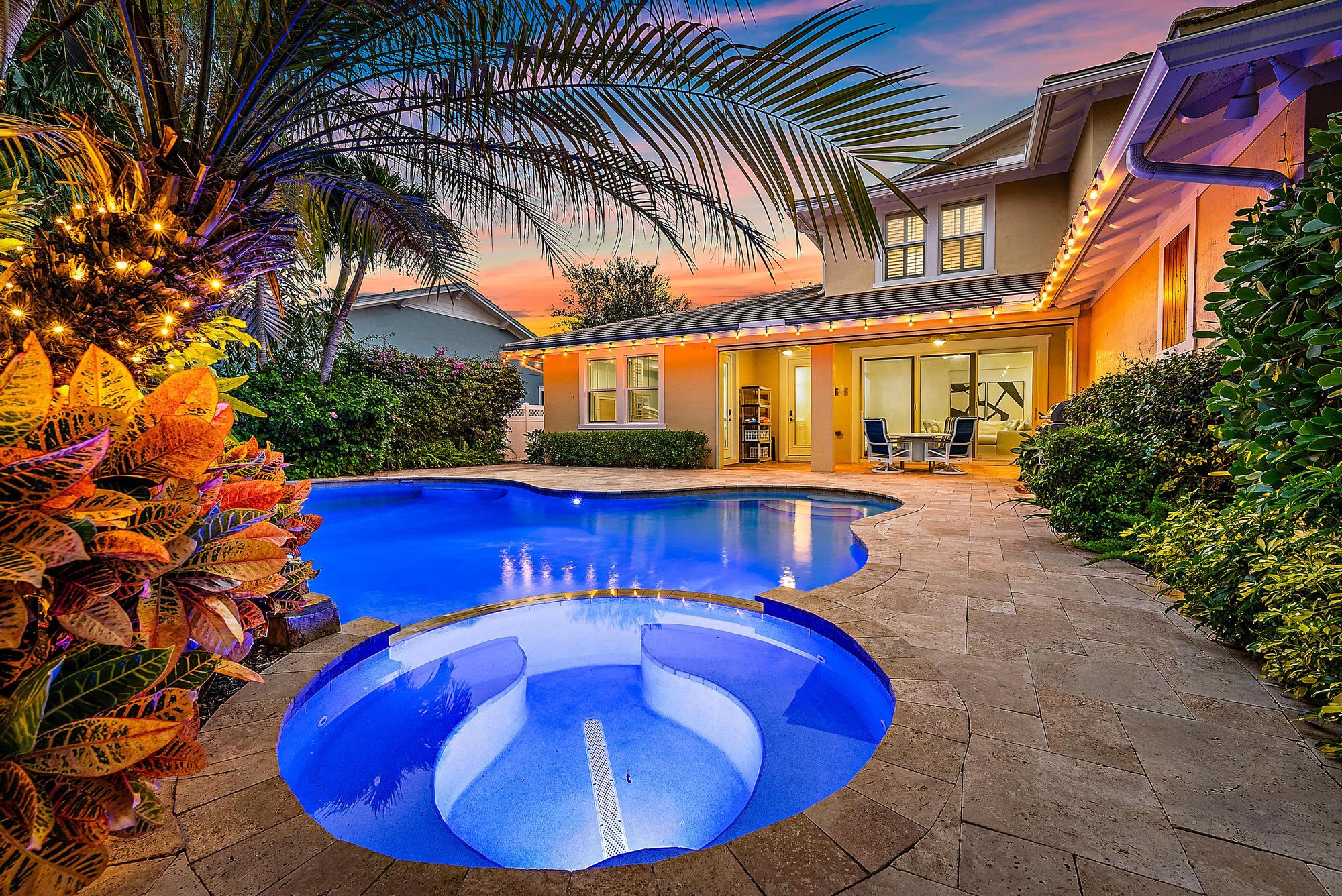 2702 West Mallory Boulevard Jupiter, FL 33458 - Photo 3 of 39 a view of a swimming pool with an outdoor seating