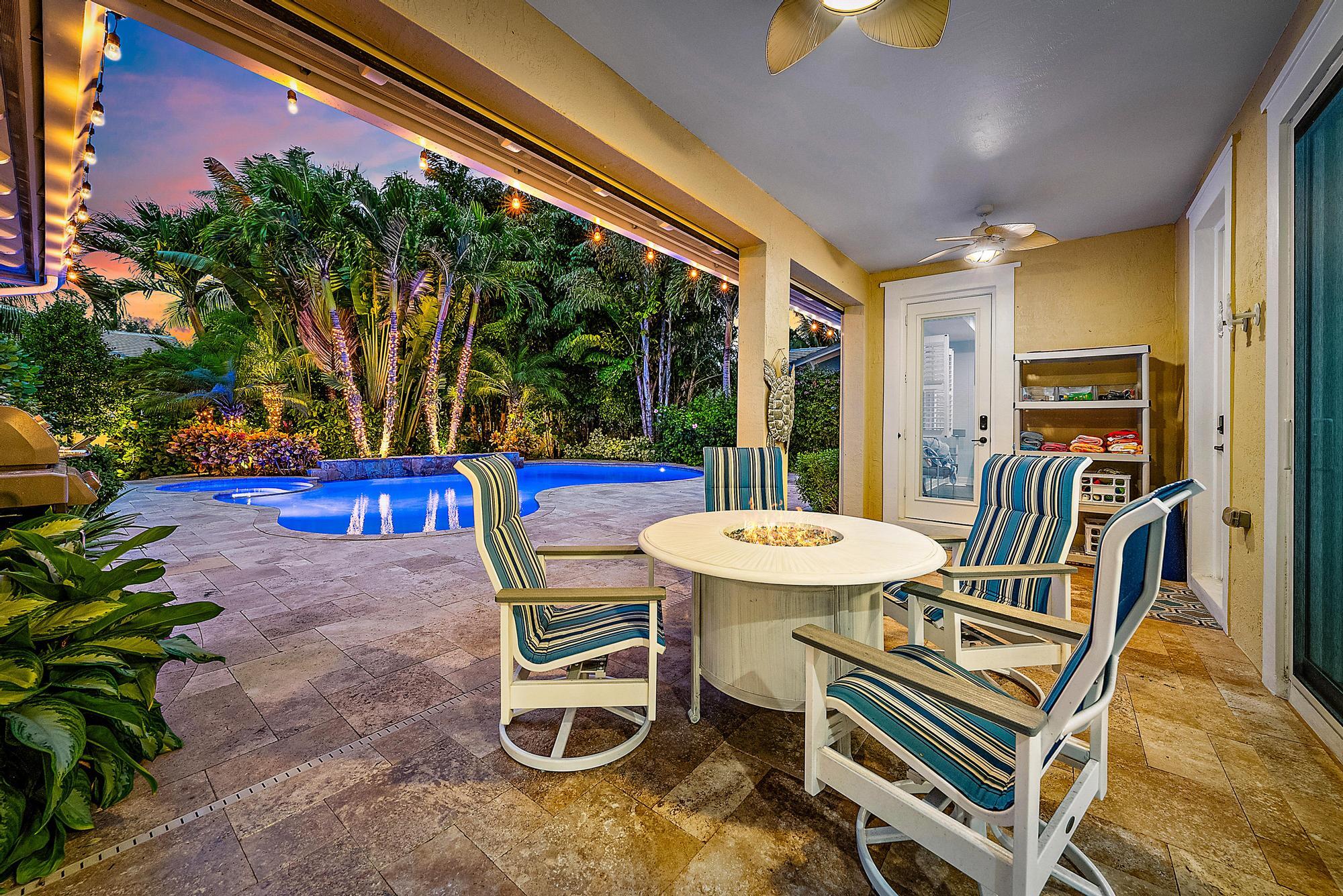 2702 West Mallory Boulevard Jupiter, FL 33458 - Photo 38 of 39 a view of a patio with a table chairs and a patio