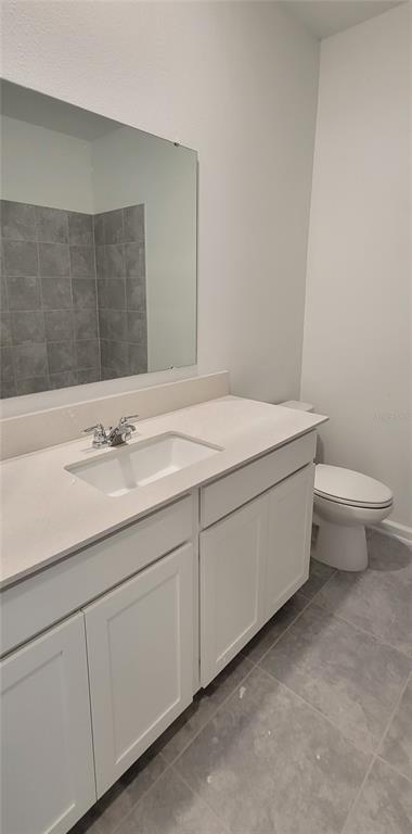 538 Hatteras Road Davenport, FL 33837 - Photo 16 of 29 a bathroom with a sink toilet and vanity