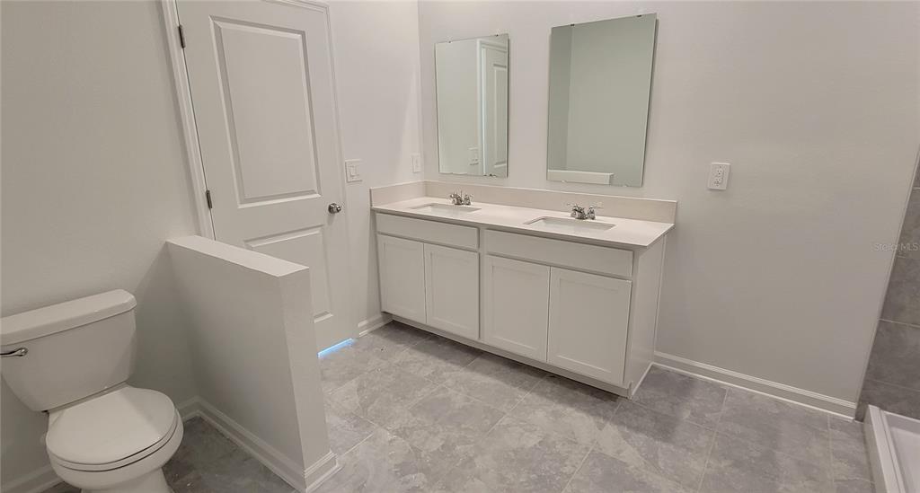 538 Hatteras Road Davenport, FL 33837 - Photo 8 of 29 a bathroom with a sink a toilet and a mirror