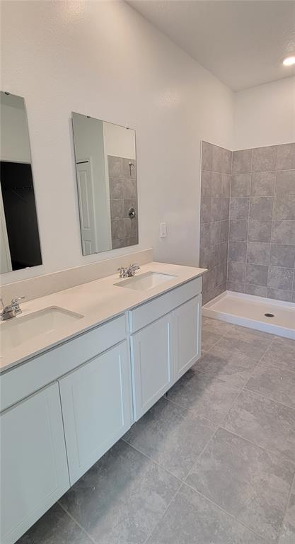 538 Hatteras Road Davenport, FL 33837 - Photo 9 of 29 a bathroom with a double vanity sink and mirror