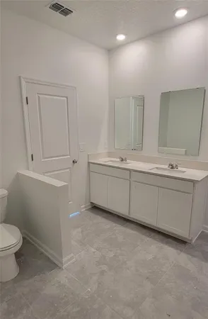 a bathroom with a sink a toilet and a vanity