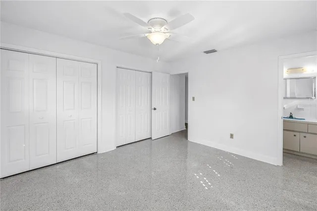 a view of an empty room with a ceiling fan