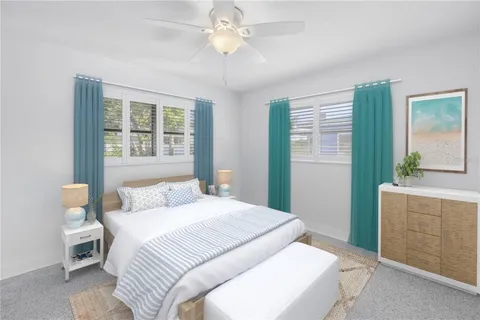 a bedroom with a large bed and a chandelier